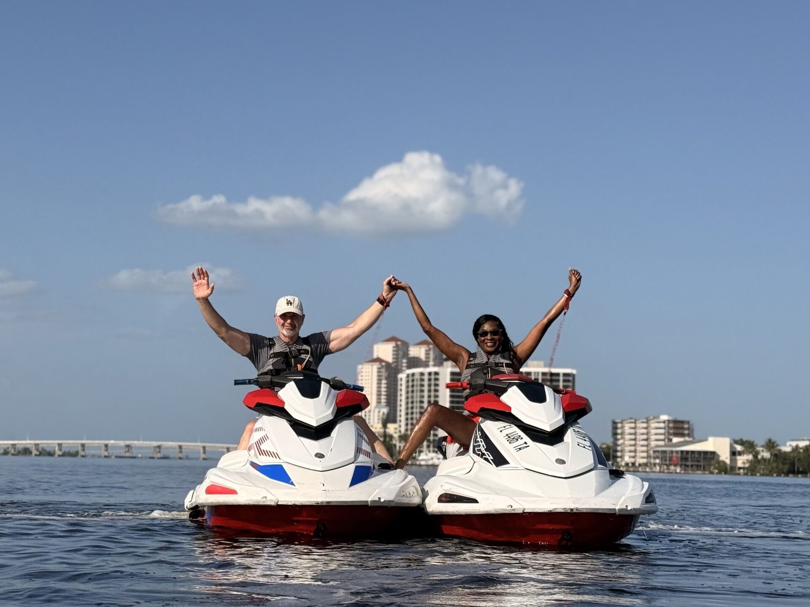 Jet ski rental riders with the Fort Myers skyline